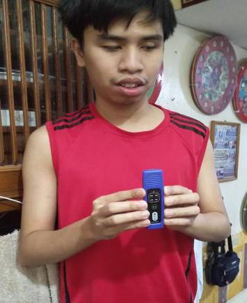 Blind young man holding an audio player.